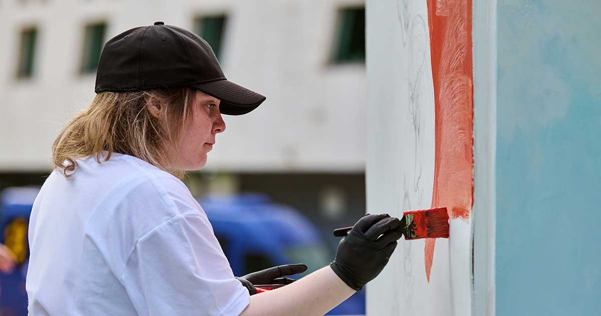 Girl painting a mural