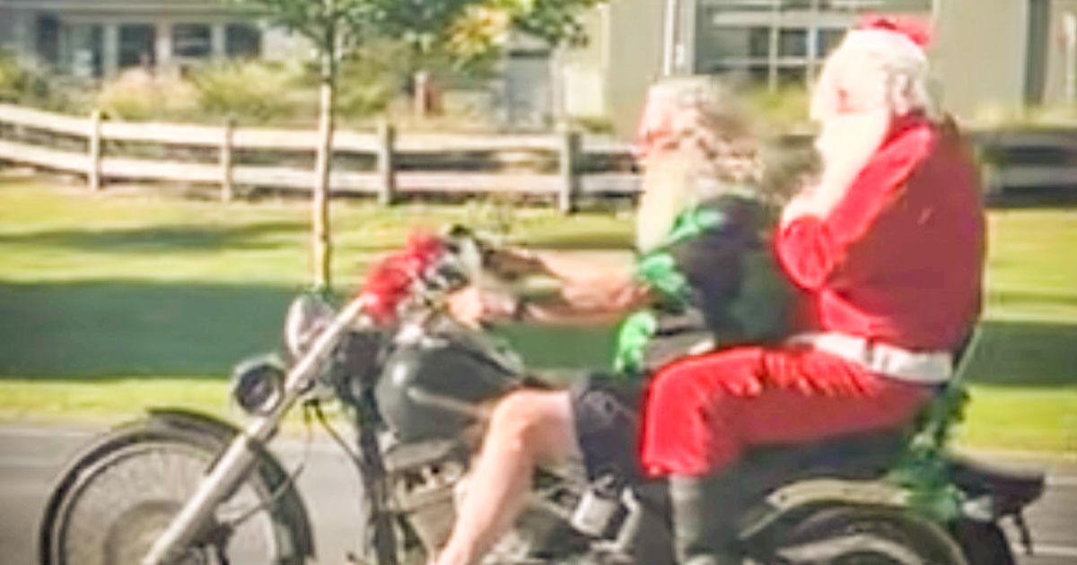 Santa on a Harley motorbike driving down the main street of Yarra Junction